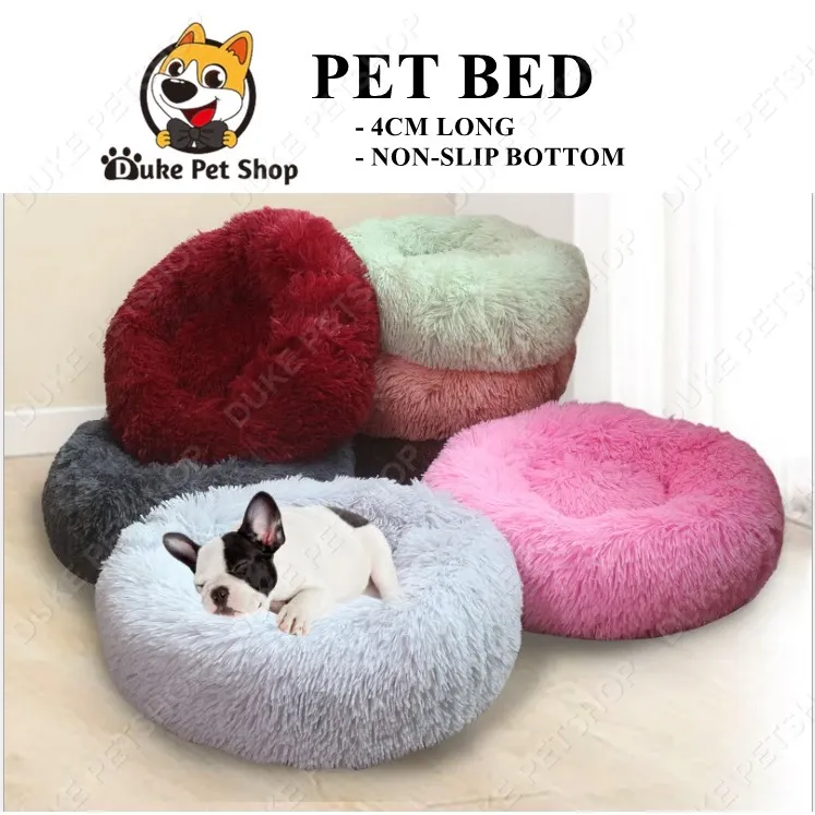 Round plush calming pet bed with raised fluffy rim, shown in cream from above