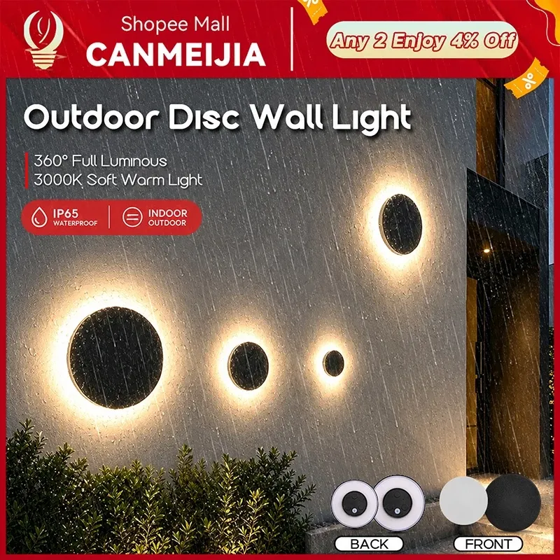 CANMEIJIA round black disc wall lights glowing with a 360 degree halo of warm light on a rain-soaked outdoor wall