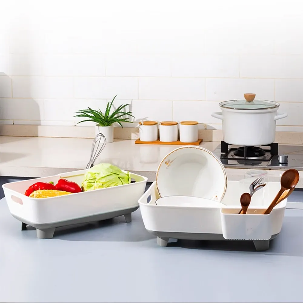 LOCAUPIN white plastic dish drying tray with grey feet, side utensil holder and a raised draining base holding a plate and cutlery, angled view