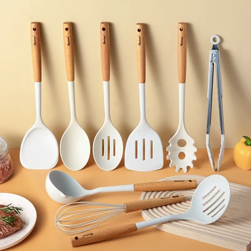 LOCAUPIN white silicone kitchen utensil set with wooden handles, including tongs and whisk, on an orange background