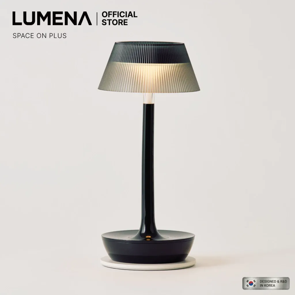 LUMENA Space On Plus cordless mood table lamp with a domed shade glowing warm on a shelf