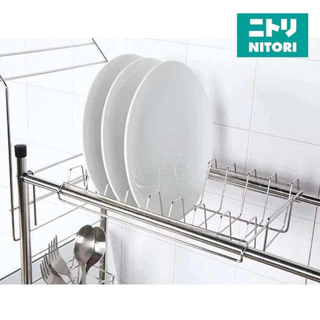 NITORI SUS stainless steel dish rack holding three white plates upright on edge, with a cutlery holder below, angled view