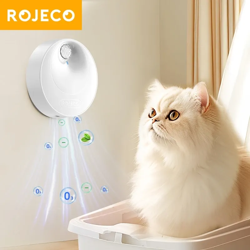Rojeco smart cat odor purifier mounted on a wall beside a fluffy white cat, front view