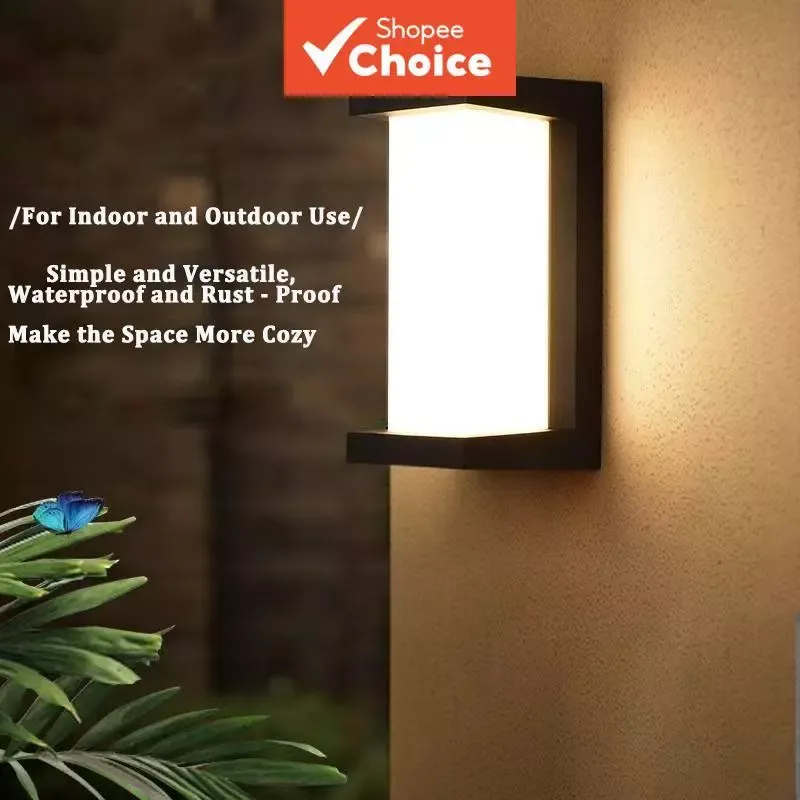 SAIMILI outdoor wall light, a frosted white panel in a slim black frame, glowing warm on a textured exterior wall