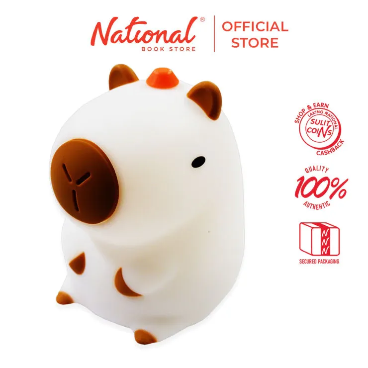 Soft squishy capybara-shaped rechargeable night light glowing warm on a bedside table